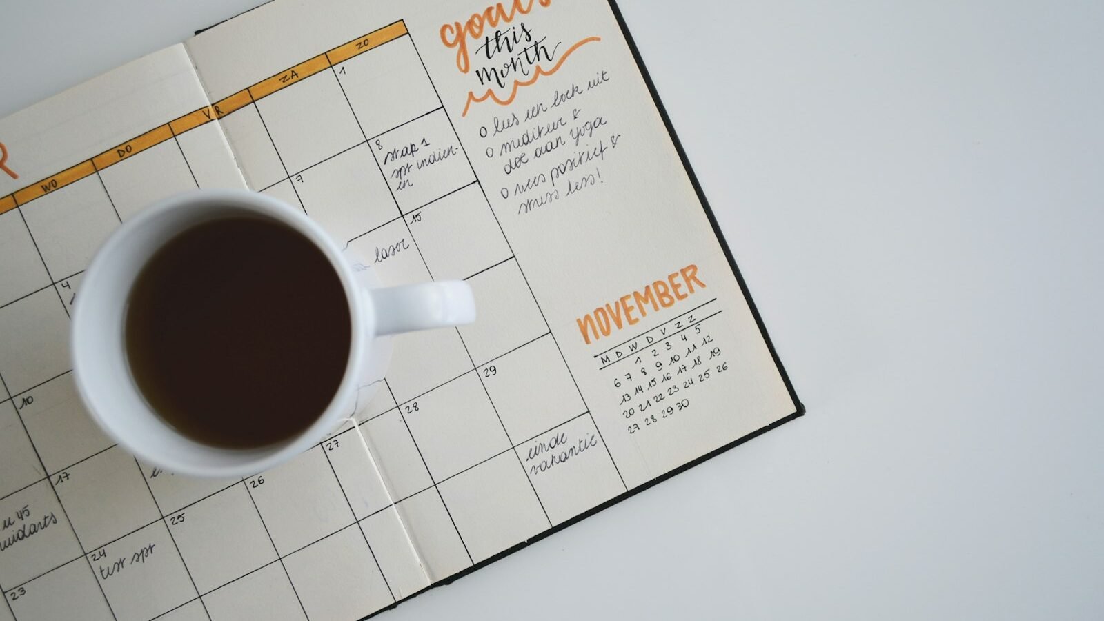 A calendar and pen on a desk
