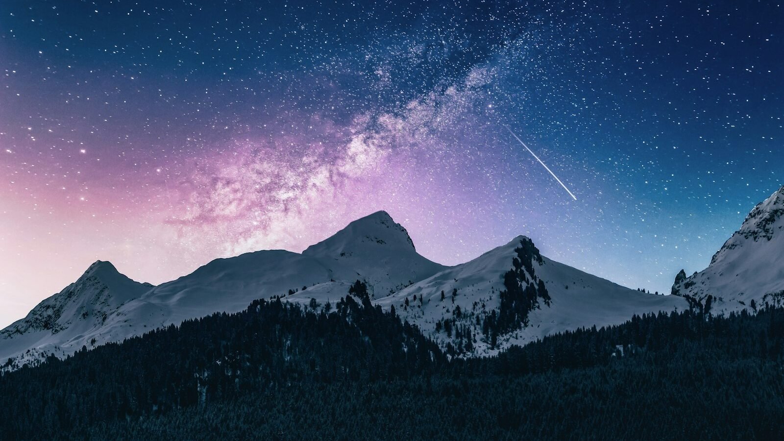 A star-lit mountain range at night